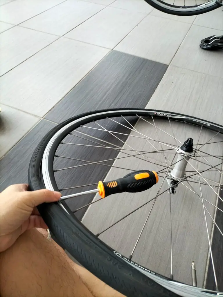 Use a Flat Head Screw Driver To Remove The Tire